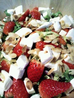 Strawberry almond salad with chicken and feta cheese.